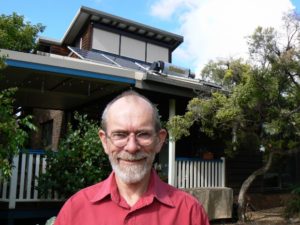Trevor Berrill in front of his sustainable home