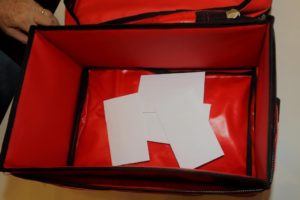 For each contest the names are put into envelopes which are then placed in the red ballot box