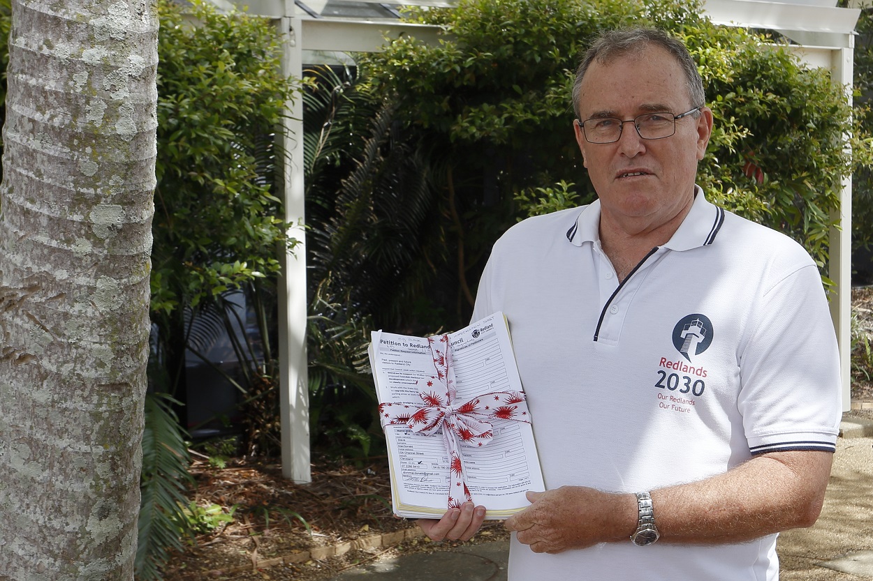 Redlands2030 President Steve MacDonald a petition calling for Redland City Council to withdraw support for the Toondah Harbour development.